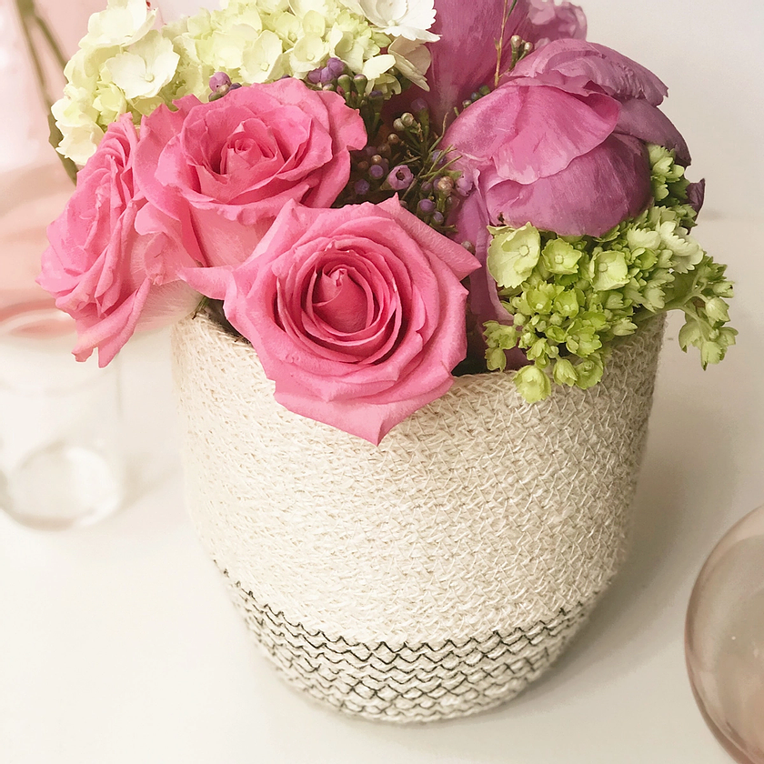 Korissa handwoven basket filled with bright pink roses and fresh florals